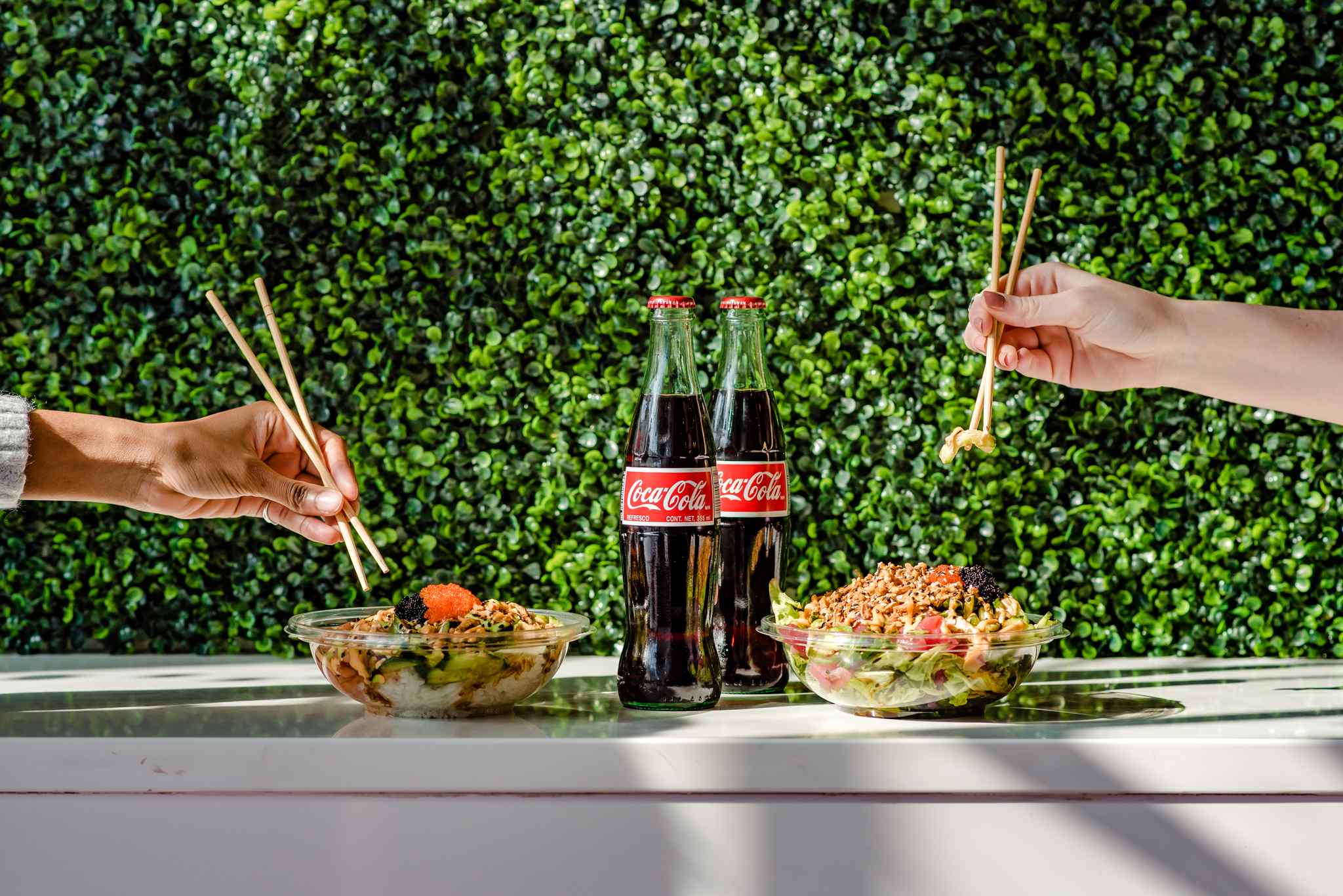 People eating poke bowls